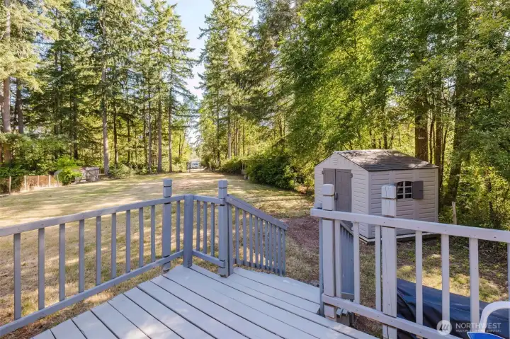 Back porch looks out onto the backyard and the second property entrance, complete with a second address for the property. Back porch looks out onto the backyard and the second property entrance, complete with a second address for the property.