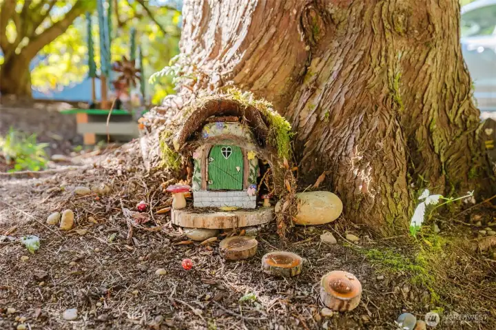 Along the driveway is the enchanted forest. Stop and see all the intricate details that accent the property line along the front. It is so charming. Along the driveway is the enchanted forest. Stop and see all the intricate details that accent the property line along the front. It is so charming.