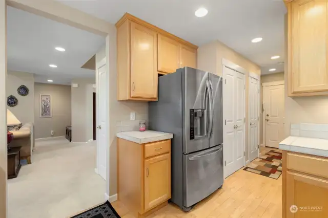 The short hallway houses a huge pantry behind the double doors, laundry room, half-bath, and convenient access to the garage.