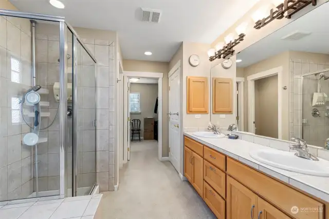 The sheer size of this ensuite is unique! Wood cabinetry, double vanities and updated lighting PLUS an enormous walk-in closet and two linen closets.