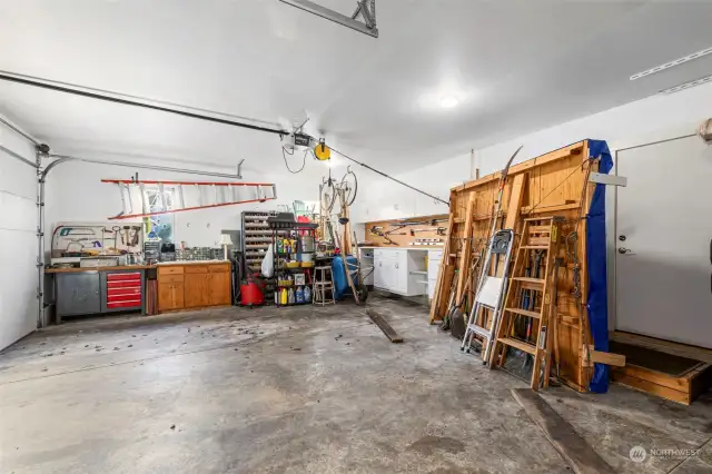 The fully-finished oversized garage boasts two different shop spaces and numerous built-ins for convenient storage.
