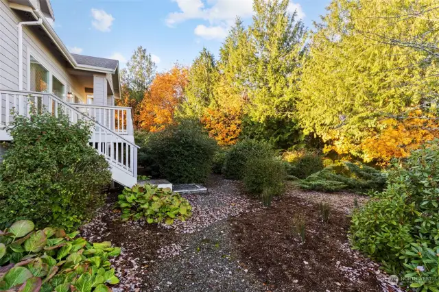 THe backyard is thoughtfully landscaped with mature native plantings, full sprinkler system, and backs up to the tree-lined open space for privacy.