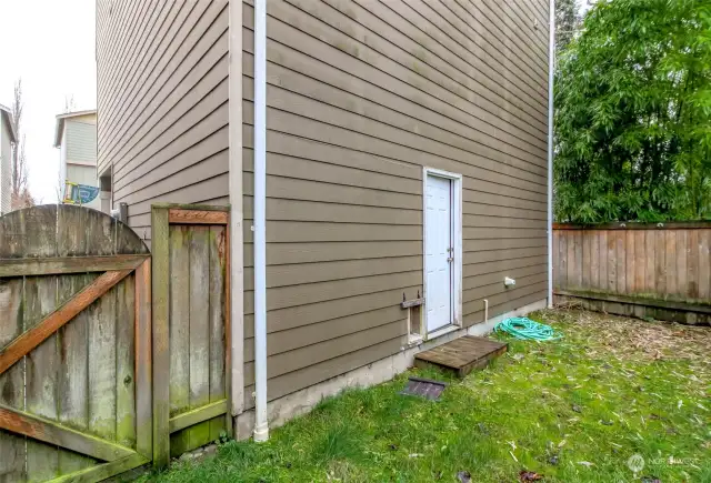 Fully fenced backyard with private door and gate.