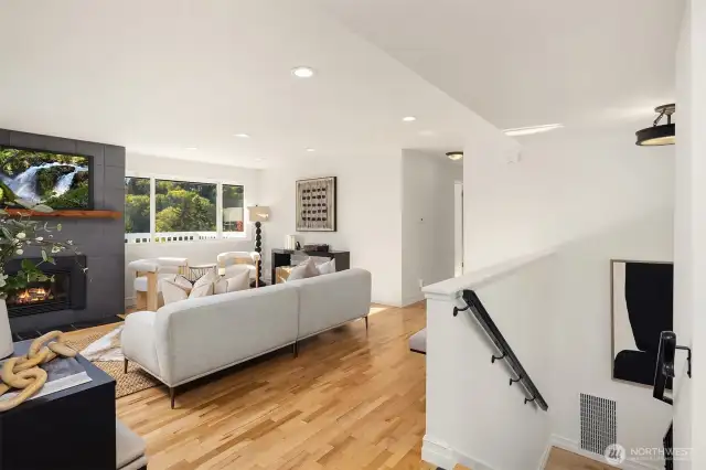Stairs near entry lead down to a large finished basement area.