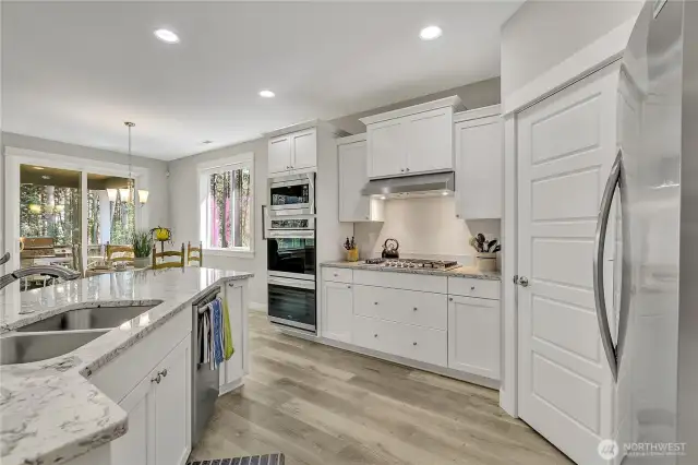 The kitchen shines with sparkling countertops and can lighting.