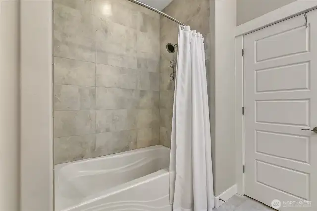 The tub/shower combo in the primary bath.