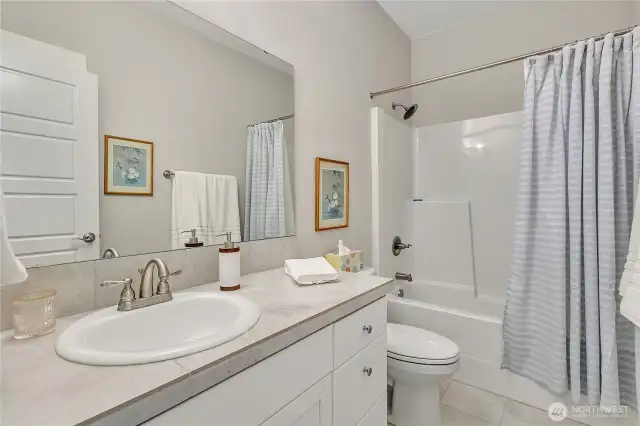 Full bath with tub/shower combo.