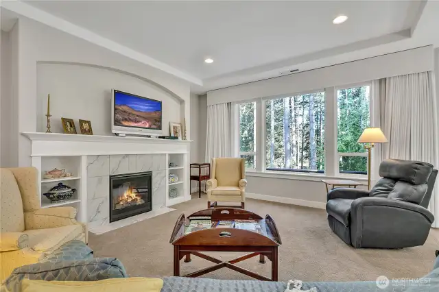 Living room features a fireplace flanked by built-ins and a niche above.