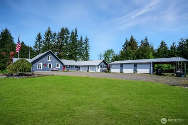 Great picture of house, attached garage, detached garage & shop