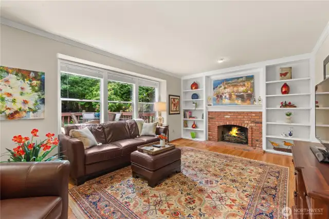 Warm and inviting family room with built-ins, and a wood burning fireplace.