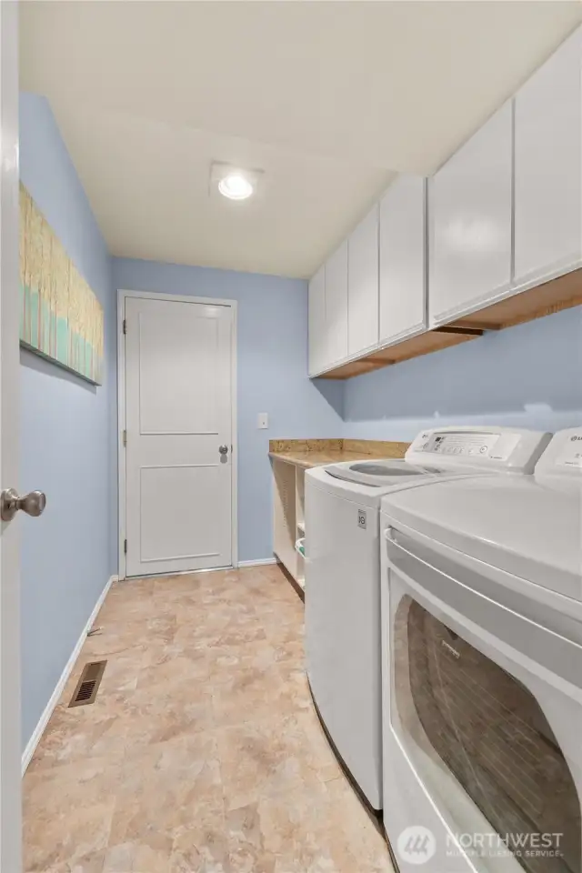 Utility room downstairs. Lots of room for folding and storage! 2-car garage is through that door.