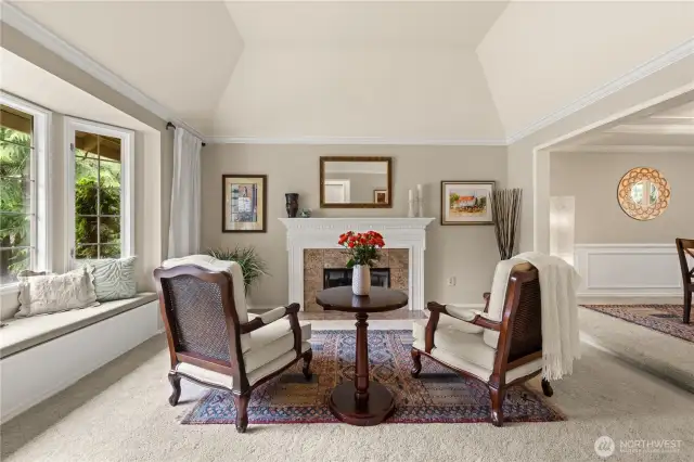 Living room off the entry with bay window, and storage in the bench.