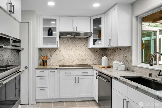 This seamless stainless steel sink and built-in microwave complete the fabulous kitchen remodel. The door on the left of this photo opens to a large pantry closet.