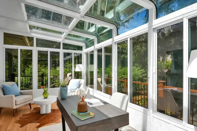 Open all of these sunroom windows in the warm season, and cozy up on a rainy winter day. Sliding doors behind the camera open onto the new Trex deck.