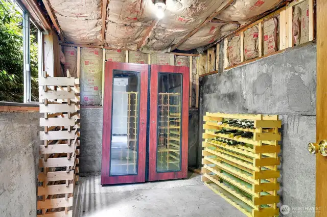 Just off of the rec room, this unfinished space has served as an excellent wine storage room. That wine fridge and those racks stay with the home.