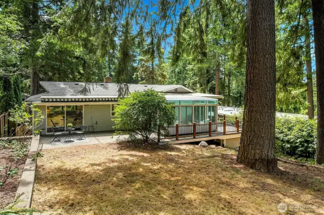 A view of the back of the home. A retractable, remote-controlled awning provides shade for the back patio when needed.