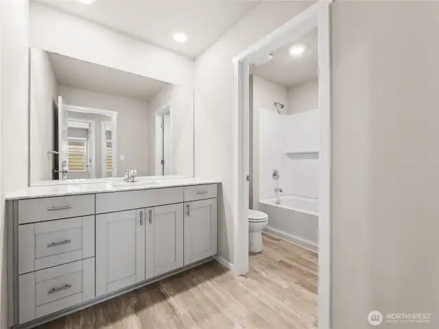 Main hall bath offers separate room for shower/bathtub and toilet.  Finishes and options will vary.