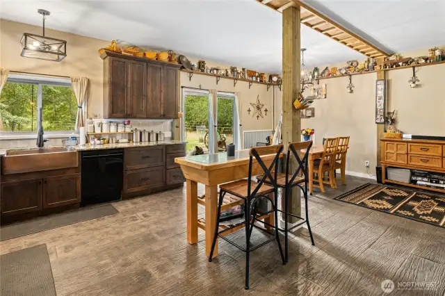 Roomy kitchen/dining space opens to the covered back porch & lush back yard!