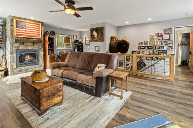 Fun loft area showcasing fieldstone fireplace, access to down stairs, & the 2nd guest room.