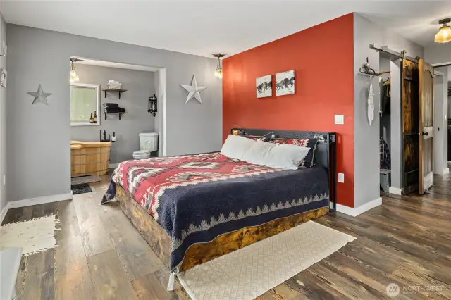 Primary suite also has dueling closets with cute barn doors.