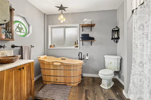 Primary Suite is cowgirl chic with this incredibly unique wooden tub & separate shower.