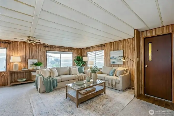 Entry and living room area. Digitally staged.