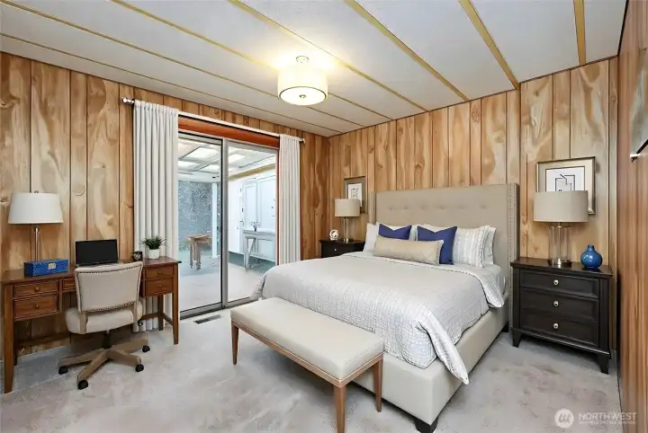 Second bedroom with slider to back deck. Digitally staged, including curtains.