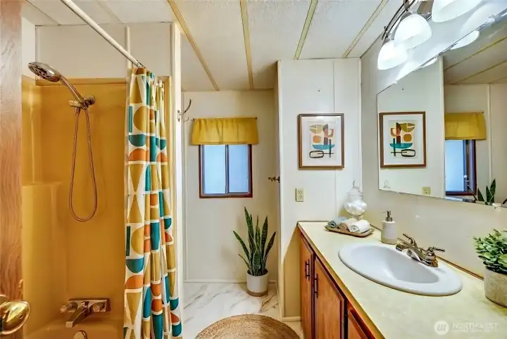 Second full bath. Digitally staged, including curtain.