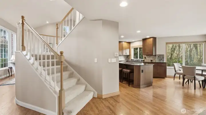 The floor plan is open and airy with views around every turn.  The staircase has a white spindles to continue how open the home flows.