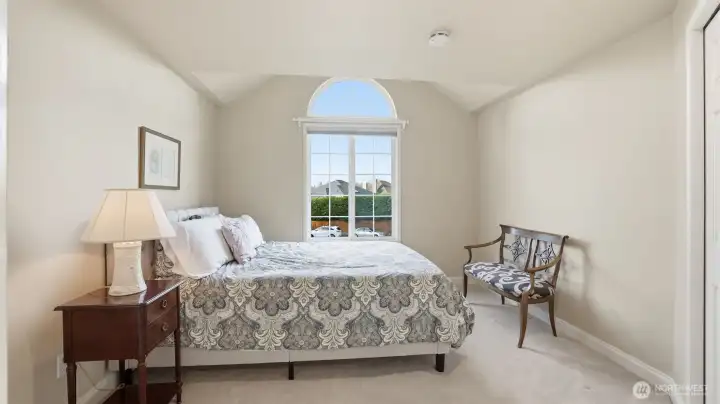 One of the 2 secondary bedrooms. It has a fun ceiling feature plus a half moon window.