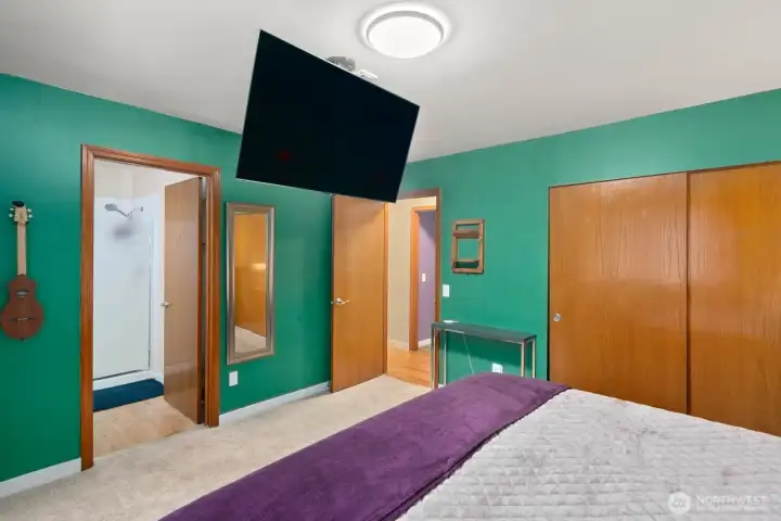Primary bedroom has ceiling remote to lower TV up and down for viewing in bed
