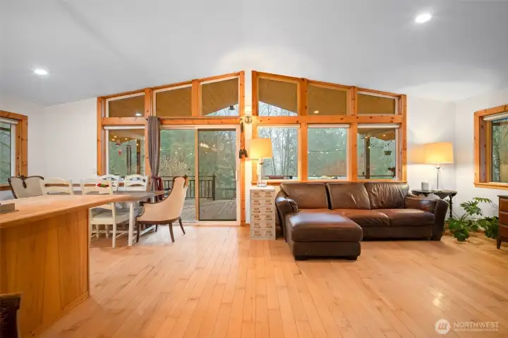 The spacious 'great room' has a wall of windows. To the left is the kitchen area and a large breakfast bar. New interior paint throughout the home too!