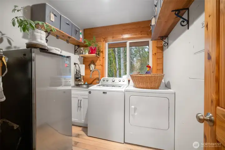 Now that's a large utility room! Fully equipped with a washer, dryer, utility sink, plus additional storage.
