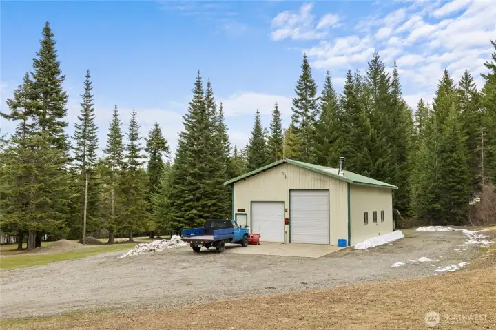 1500sf heated shop! Includes a 3/4 bath with washer/dryer hookups & storage area. Wired for welder & generator. Includes a drill press & air compressor. Storage racks, fridge/freezer, & work benches stay. Cool ramp/lift for snowmobile storage too!