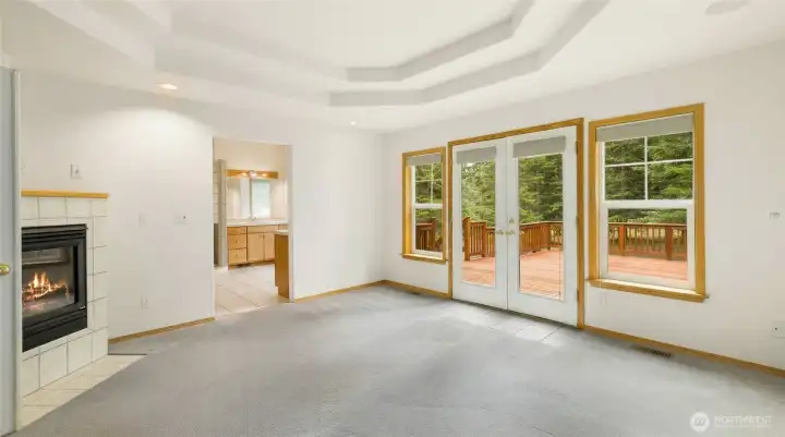 Primary Suite features a cozy corner propane fireplace.