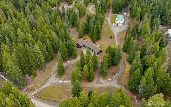 This parked out 5+ acres consists of a circular driveway for the home, plus roads to the shop AND around the property!