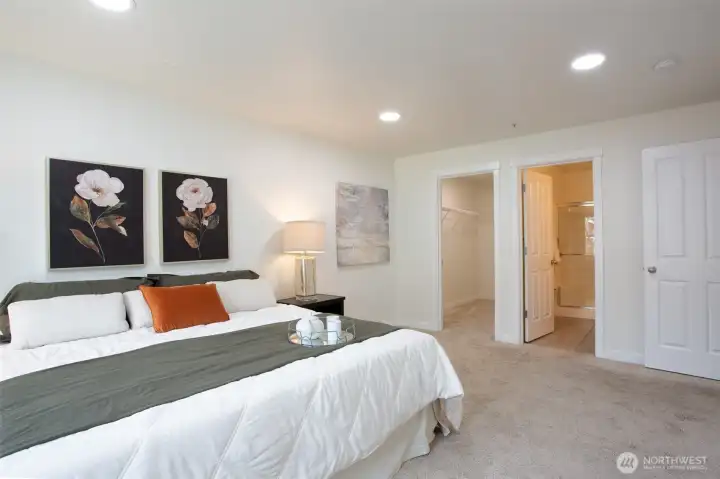 Another view of the Spacious Primary Bedroom with an attached Walk-In-Closet and Bathroom.