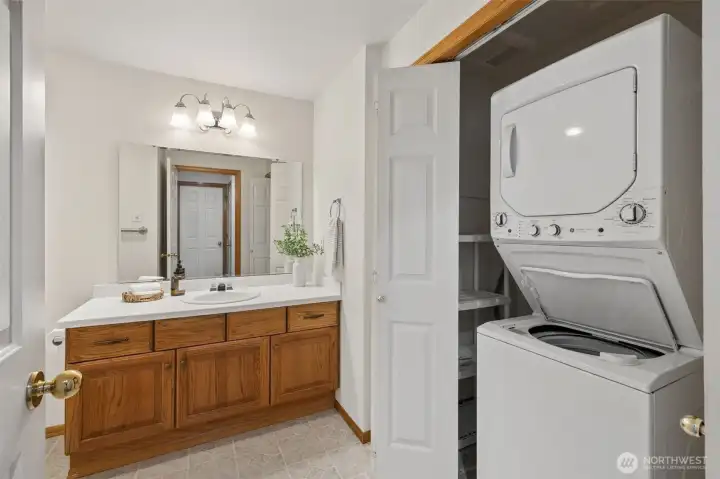 Convenient stacked laundry in guest bathroom closet.