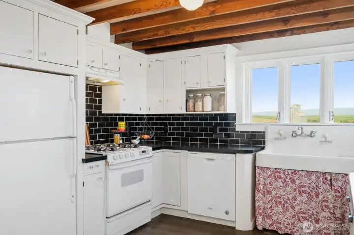 Kitchen updates include newer cabinets, dishwasher & gas range