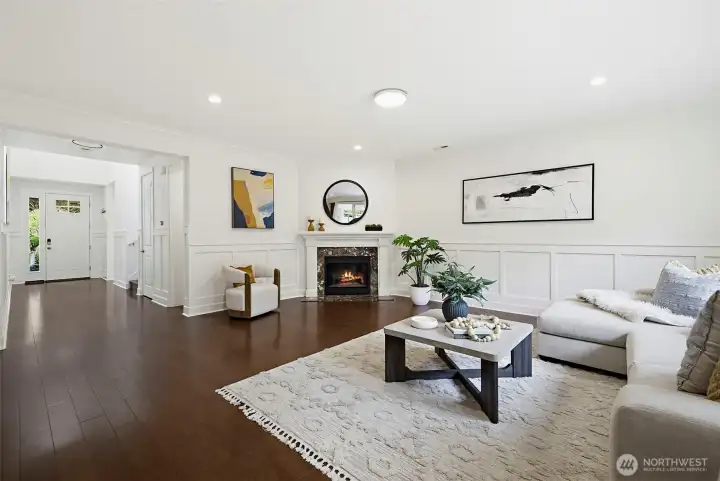 Wainscoting through the main floor, 9’ ceilings, gas fireplace and rich hardwood flows through