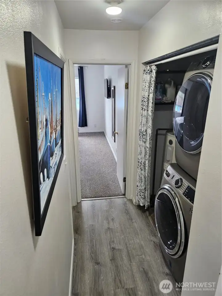 The washer and dryer are conveniently located in the hallway.