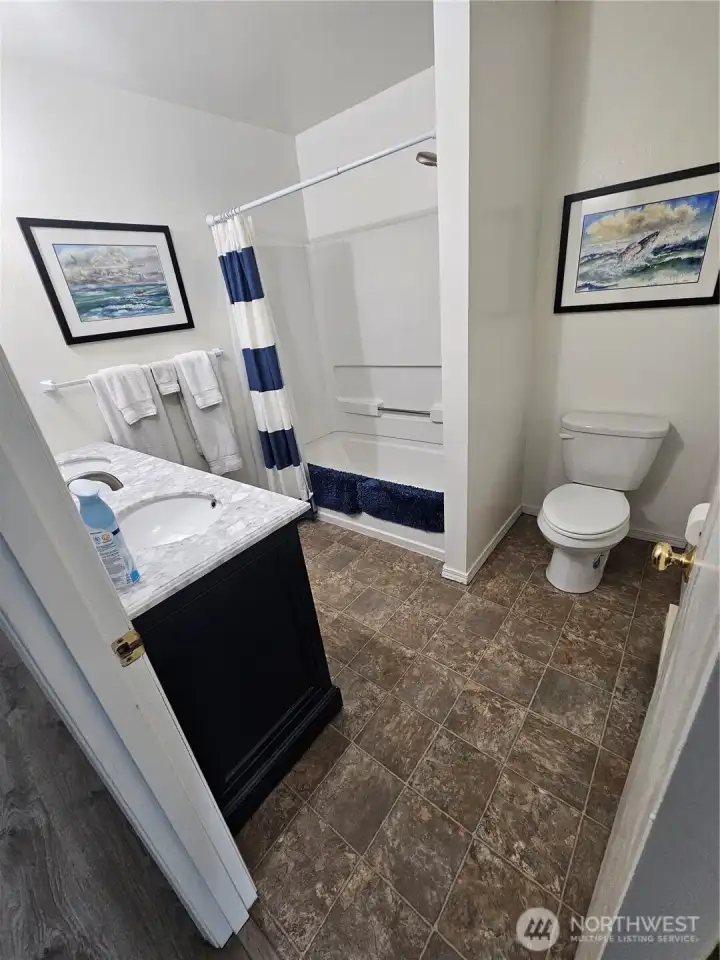 The bathroom has a double sink, a huge shower/tub and lots of room.