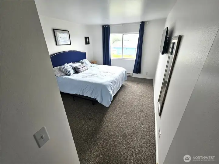 The spacious primary bedroom is right next to the bathroom .