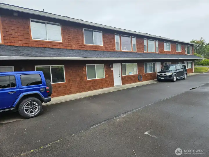 This is the view from the street. Parking for the upper level is around the back with a level entry. The upper level is quiet and private. Unit #202 is on the top right, windows 3 and 4 from the right.