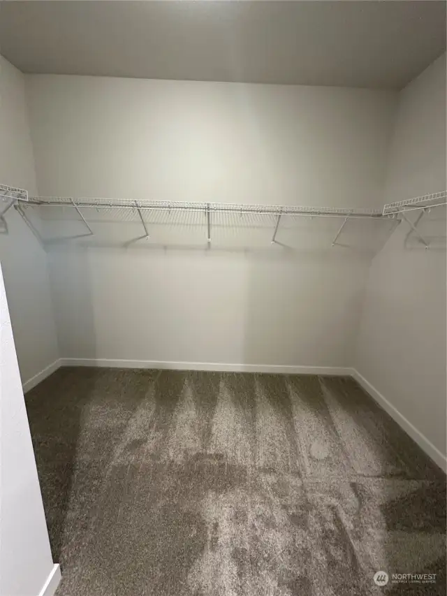 Generous walk in Primary Closet! Disclaimer: These photos are of another Aurora Home in community. Depictions of home, layout, location or other features, colors and color scheme, materials, fixtures, etc. are for showing purposes only and may not be included in the purchase price and availability may vary.