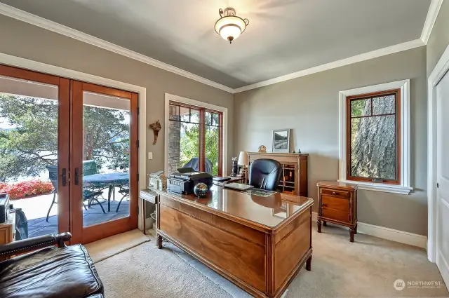 Main level home office with french doors leading to a covered patio facing the lake.