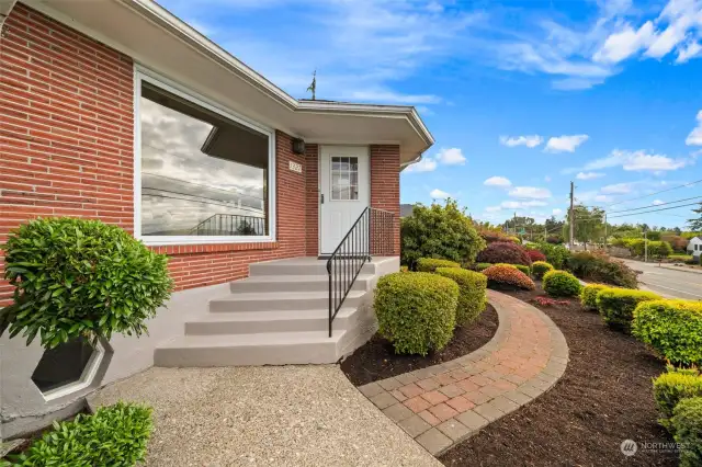 Welcome home! Brick pathway leads to front door and around back