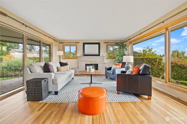 Gorgeous sandstone fireplace, floor to ceiling windows