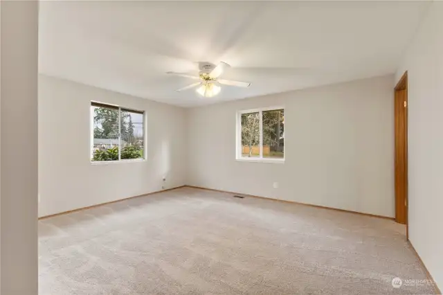 Primary Suite, lots of light and ceiling fan.