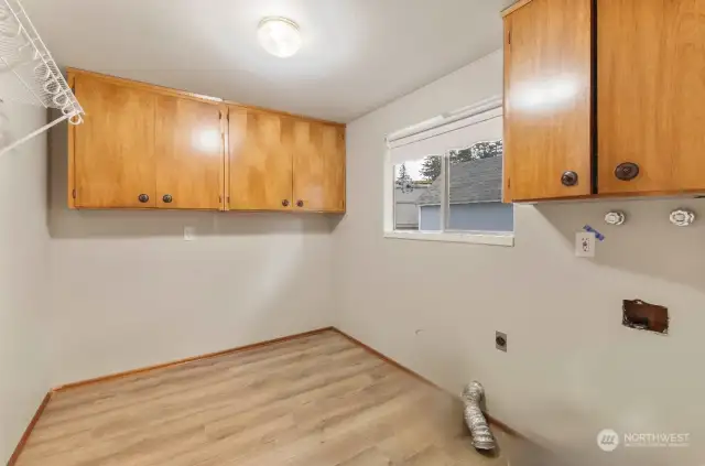 Extra Large Laundry room, with extra cupboards for storage.